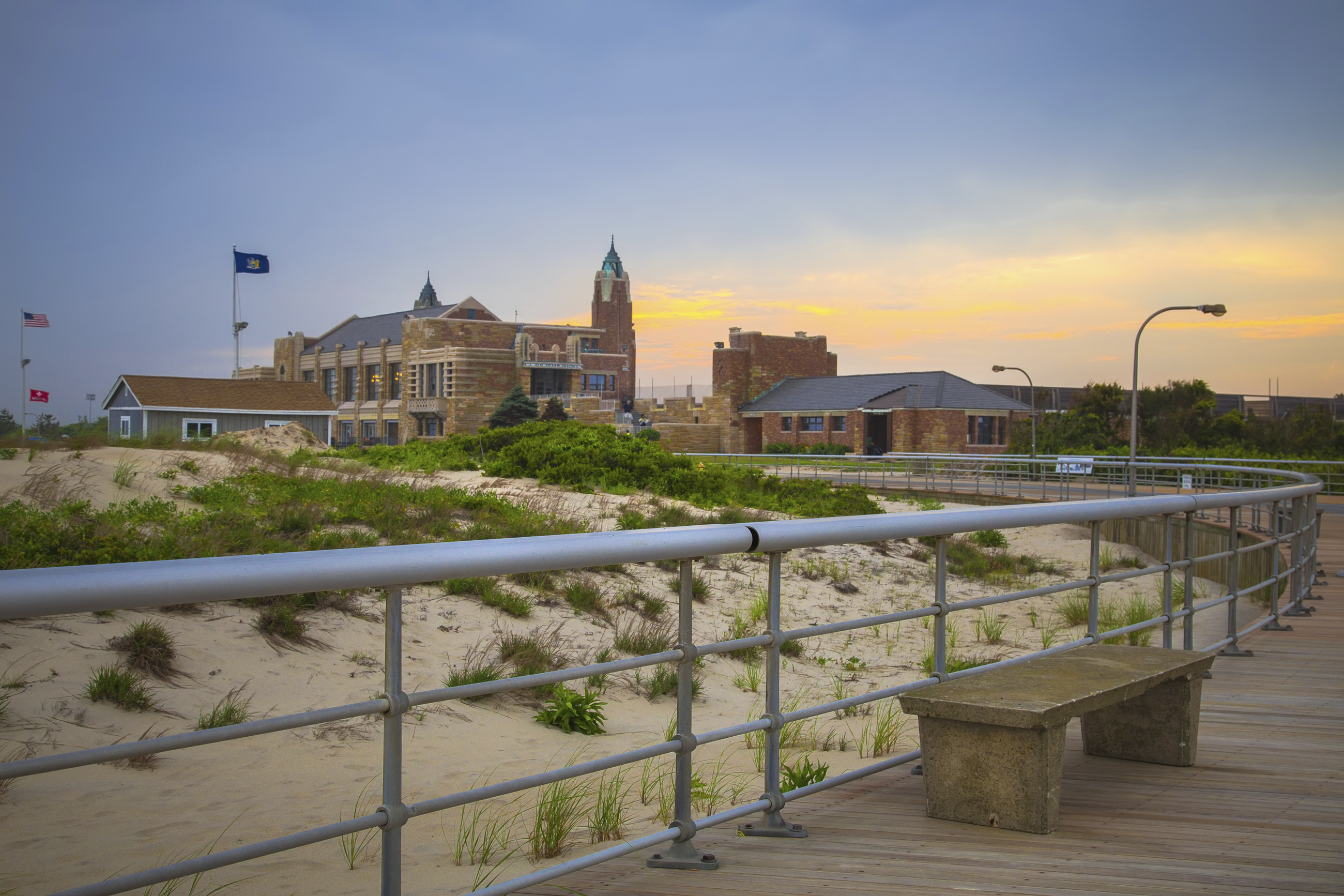 Sunset over boardwalk and bathhouse at historic Jones Beach State Park. This Long Island landmark commissioned by Robert Moses opened to the public in 1929.