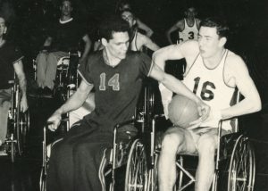 Students in wheelchairs playing basketball in the 1950s