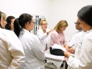 Faculty provides hands-on learning opportunities to a group of nursing students.