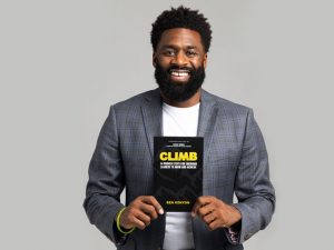 A Black man holds up a book that reads: Climb: 14 Proven Steps for Emerging Leaders to Grow and Achieve, and underneath it reads: "Ben Kenyon."