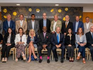 A large group of individuals, both men and women, are gathered for a formal portrait of our Board of Trustees.