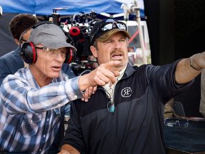 Robinson and Harris both point to action off screen, with film cameras behind them.