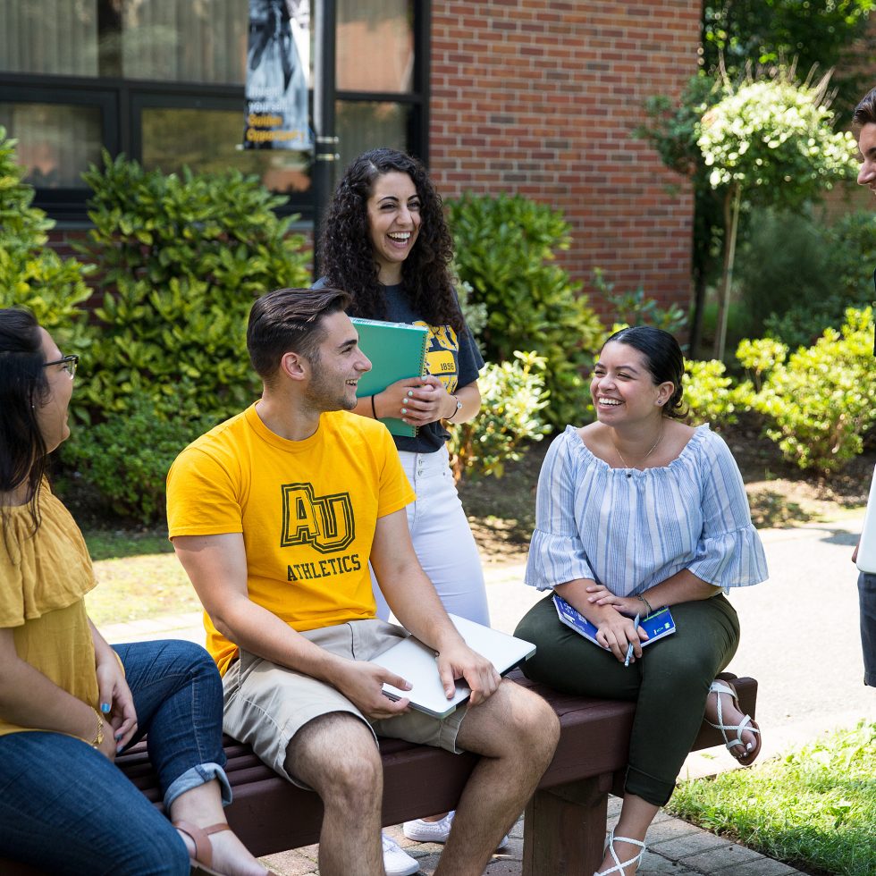 A diverse group of students talking on campus.