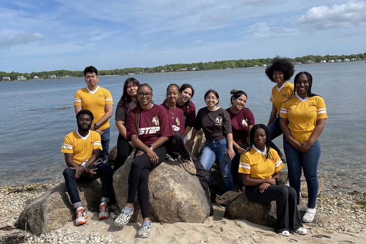 A group of students by the shore doing fieldwork