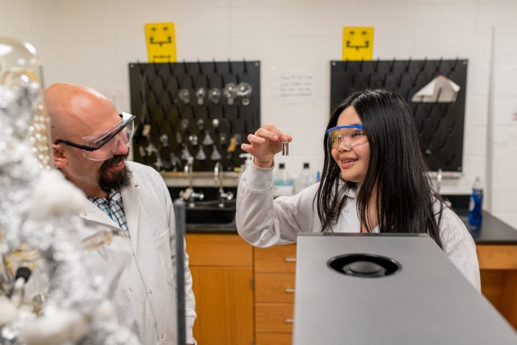 Professor Silverio working with a student in the chemistry lab