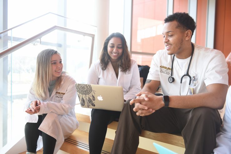 Nursing and Public Health students talking on the steps on the nexus building at Adelphi University