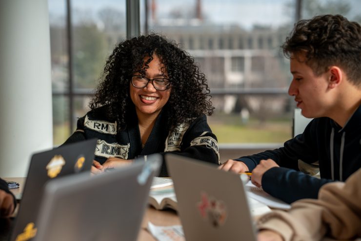 Adelphi student studying in the Nexus Building on campus.