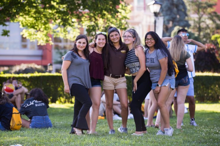 A group of students hanging out on campus - posing together at a social event