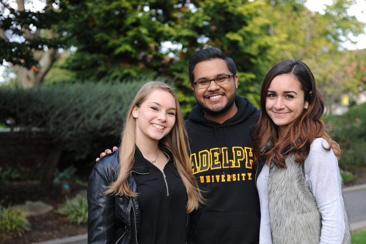 Group of international students outside on campus at Adelphi University