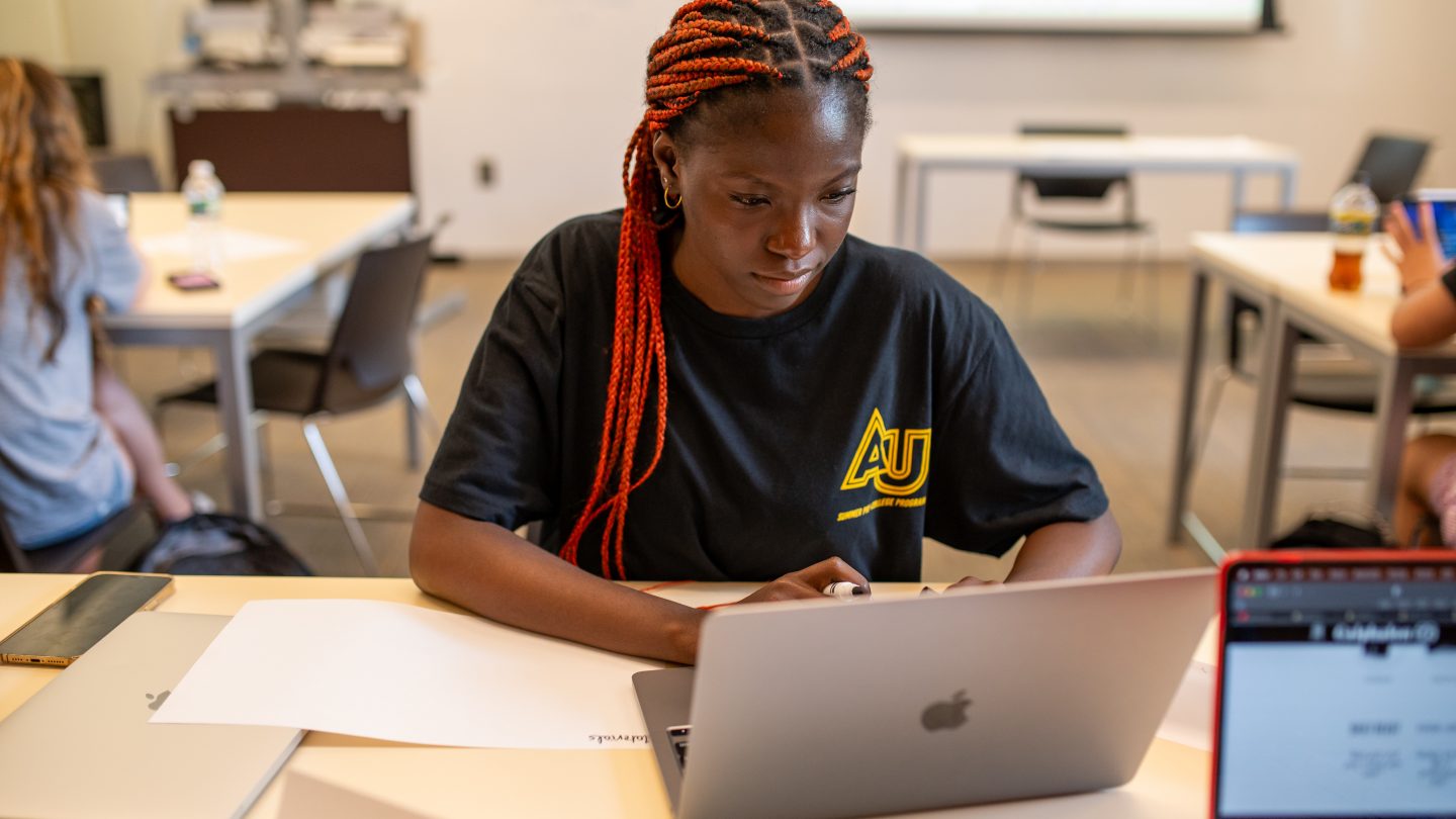 Adelphi student on her laptop