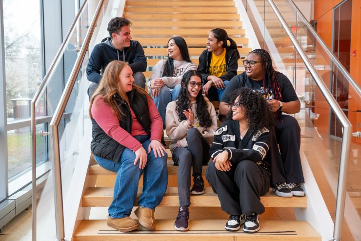 A diverse group of undergraduate students on the Adelphi Nexus steps.