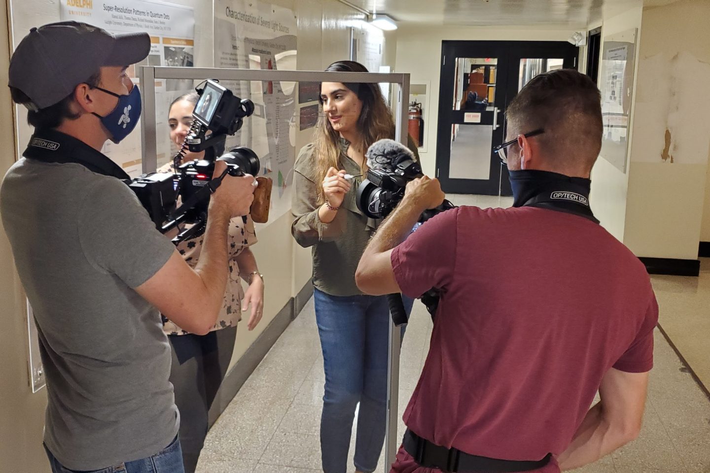 STEM superstar Areeba Khalid ’21 in the halls of the Science building, writing an equation for the cameras.