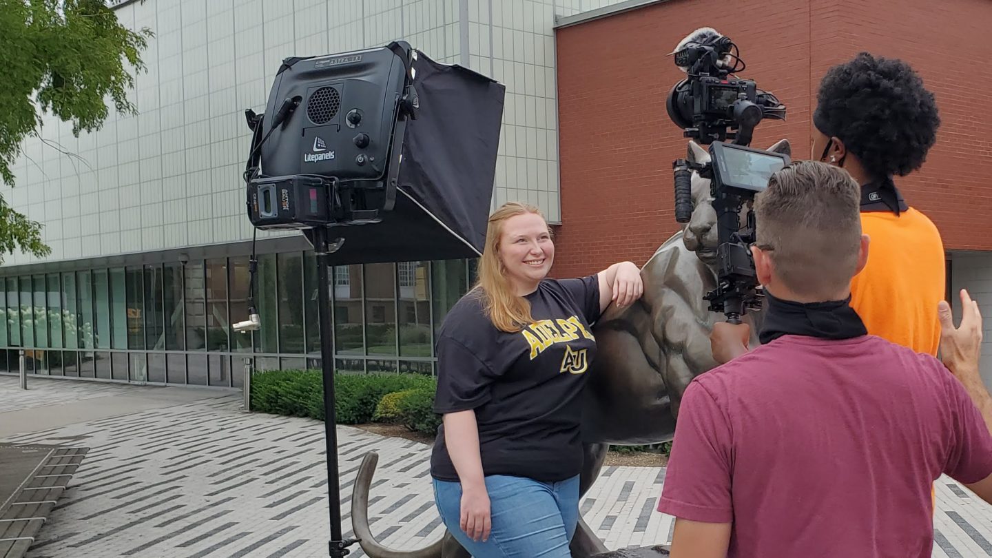 Sarah Carbain at the Adelphi Panther statue shooting for The College Tour
