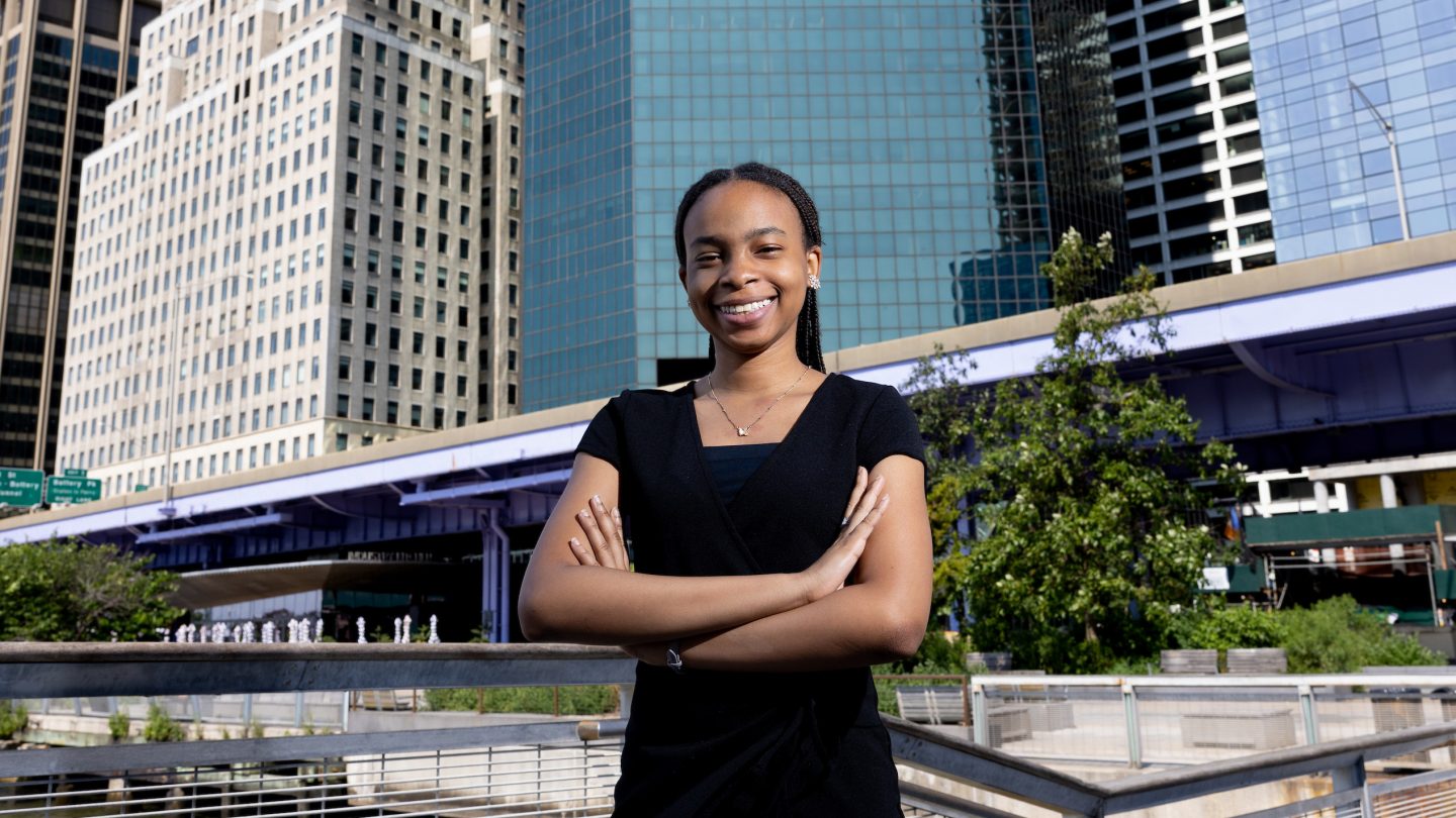 Candace Garwood, and Adelphi University alumna, stands confident by the NYC skyline.