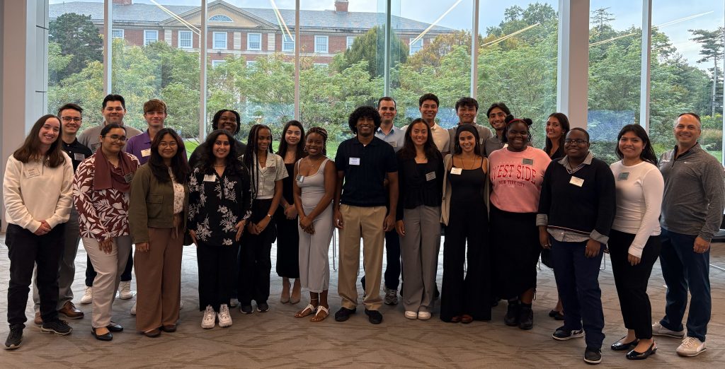 Large group of students in front of a window.