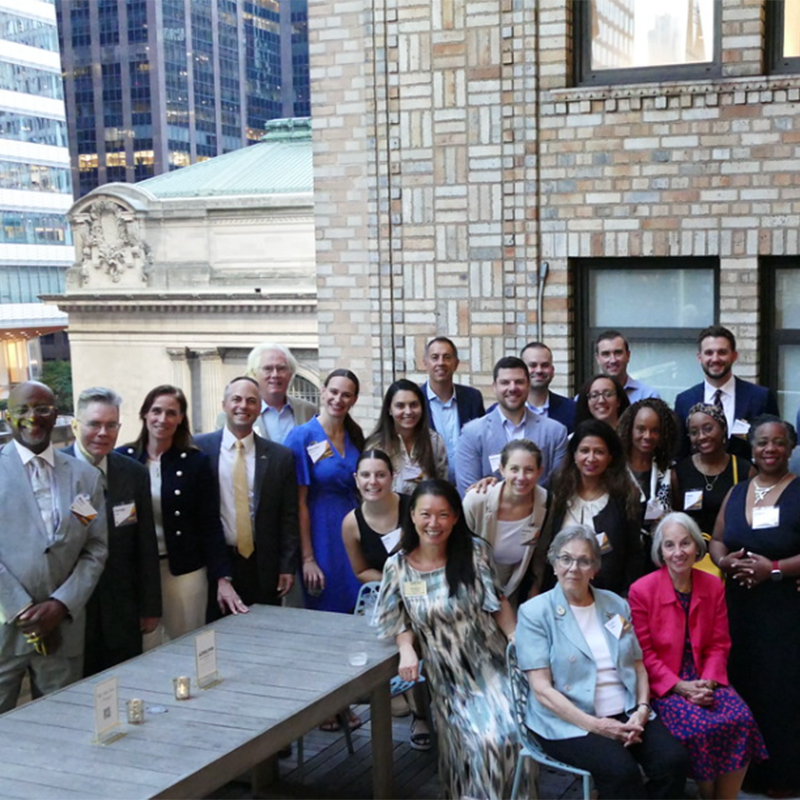 University Advancement staff and the Adelphi President with alumni and friends