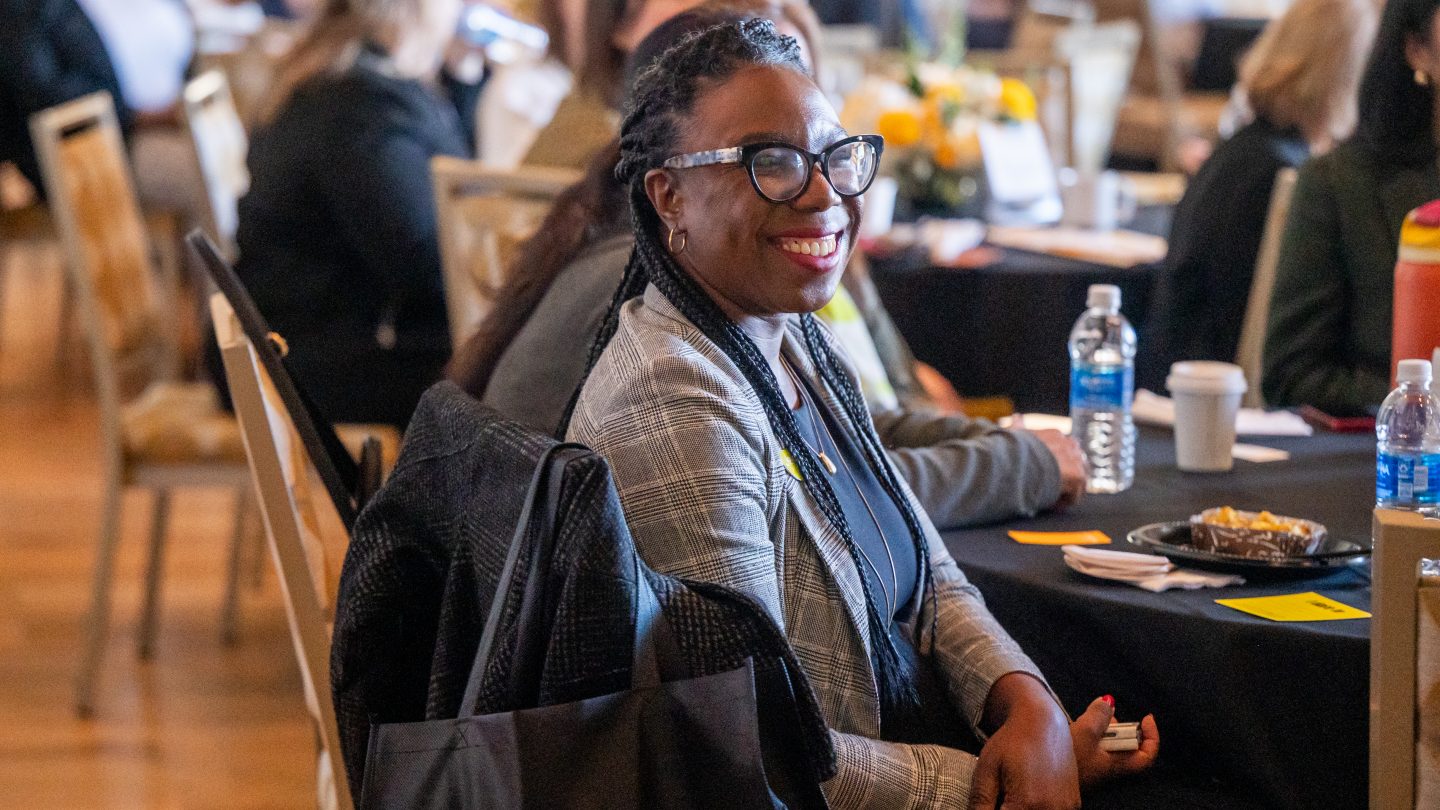 Woman smiling at Adelphi's annual Women's Leadership Conference.