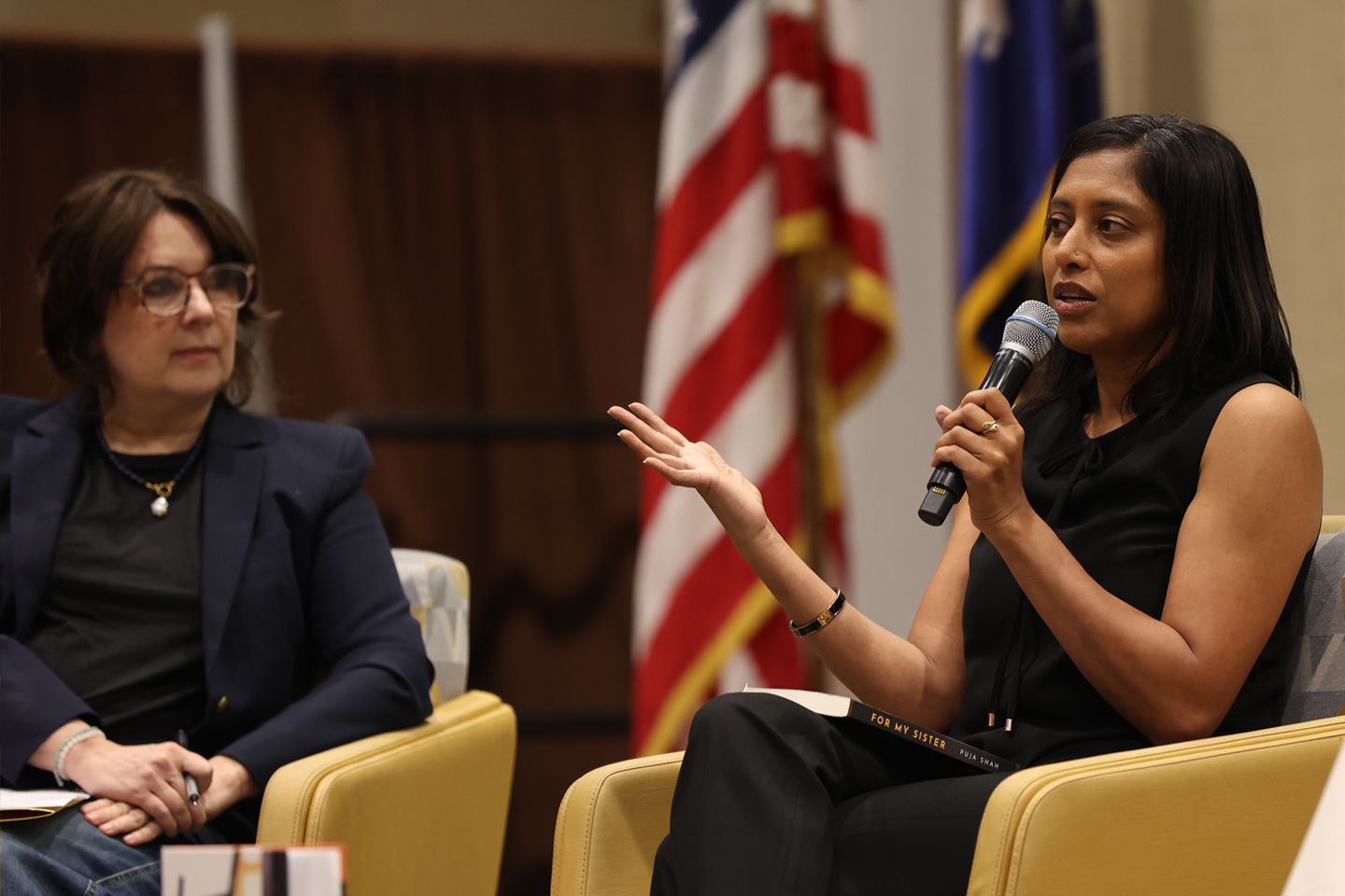 Puja Shah ’03, DMD (with mic), an alumna and current student in Adelphi’s MFA in Creative Writing program, discusses her novel, For My Sister, in a panel discussion devoted to first books by MFA students.