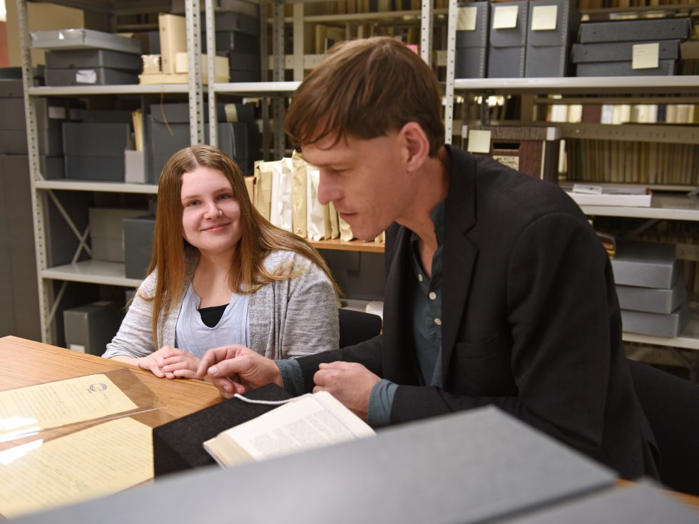 History professor Edward Reno working in the Adelphi University archives on campus.