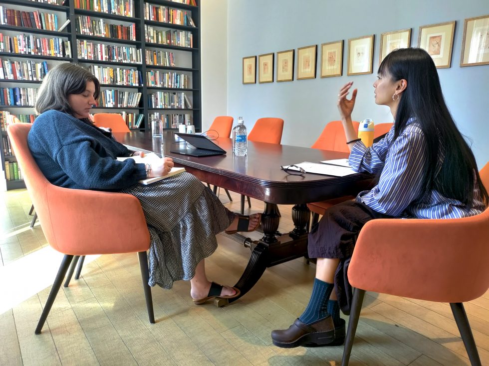 Two Adelphi University MFA creative writing students in deep discussion at the Brooklyn Center.