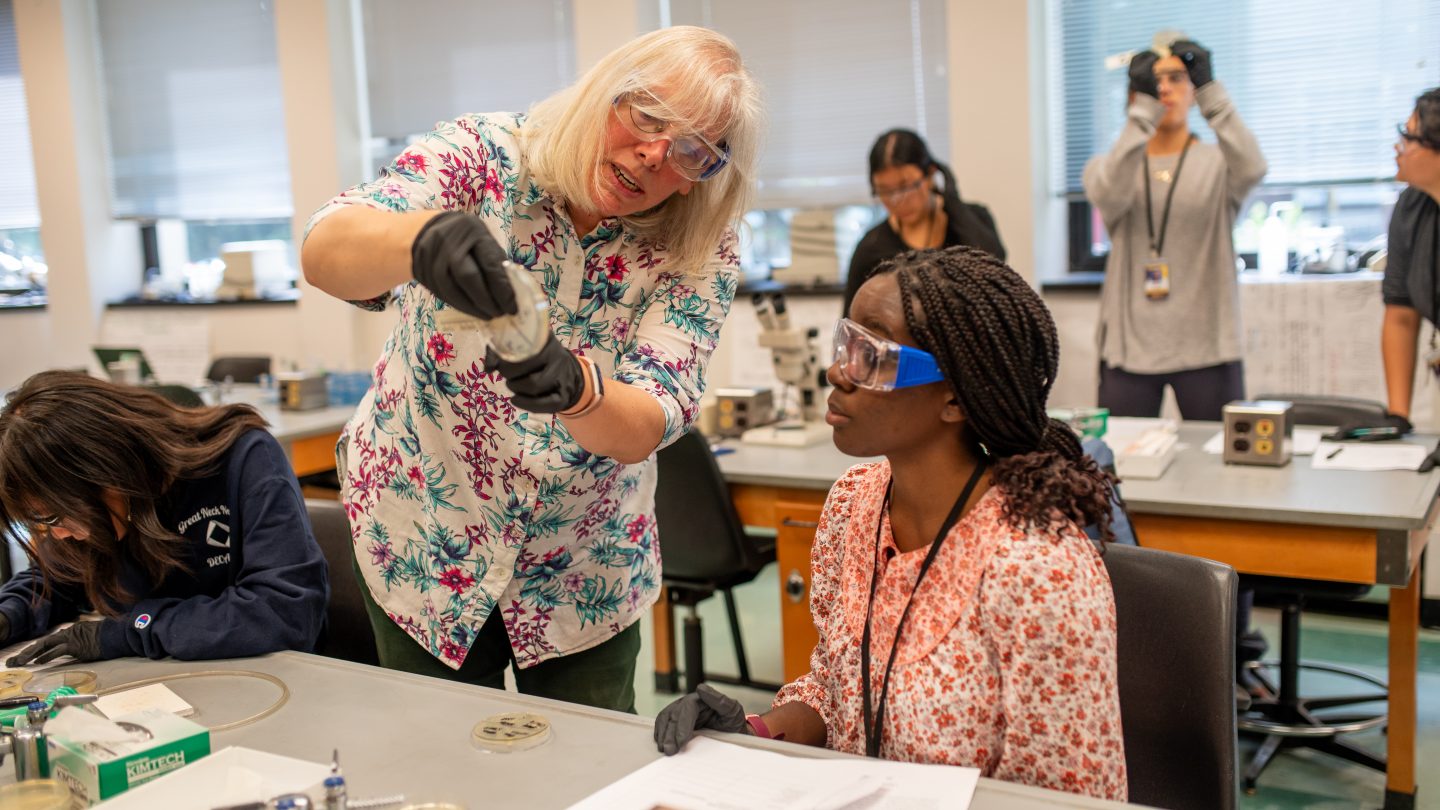 Adelphi biology professor working closely with high school students at Adelphi's Summer Pre-College program.