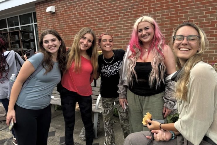 Art student pizza party outside the ceramics kiln