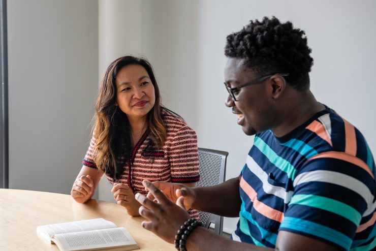 Adelphi professor Sokthan Yeng working one on one with a student.