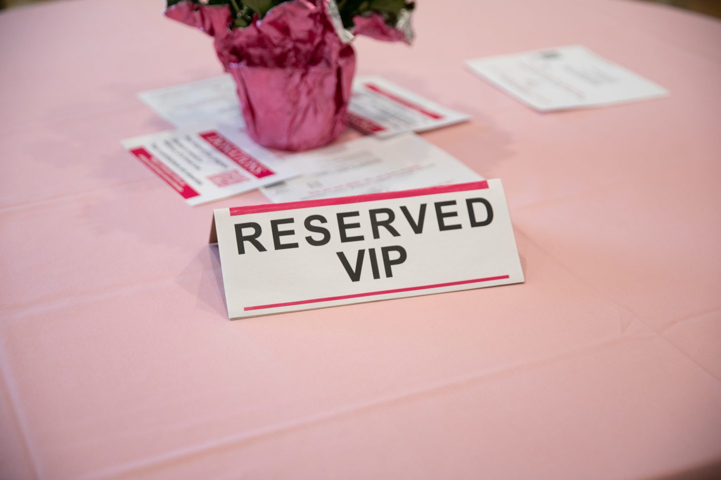 Reserved VIP sign on a pink table