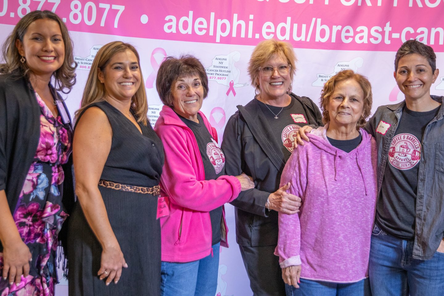 Six women in front of a backdrop