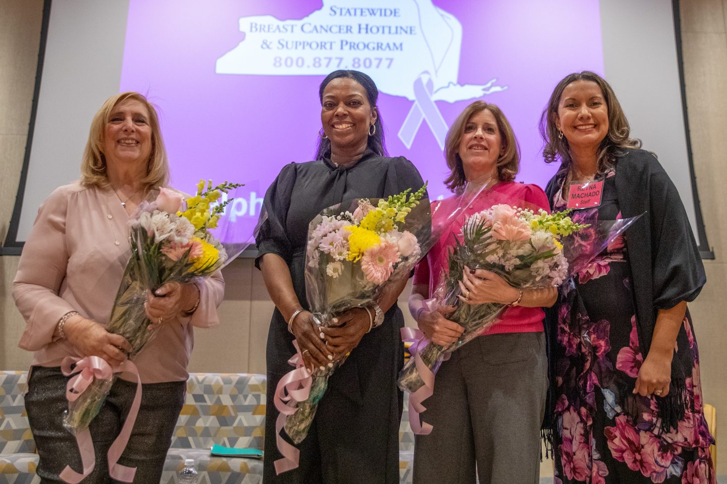Four women with bouquets of flowers