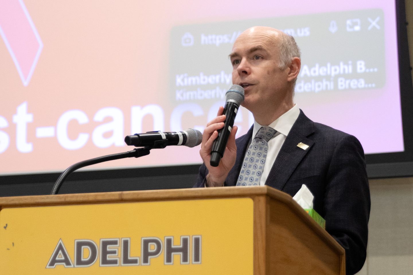 Man with a microphone speaking