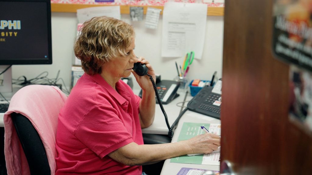 Adelphi Breast Cancer Hotline Volunteer Anne H. answering a call.
