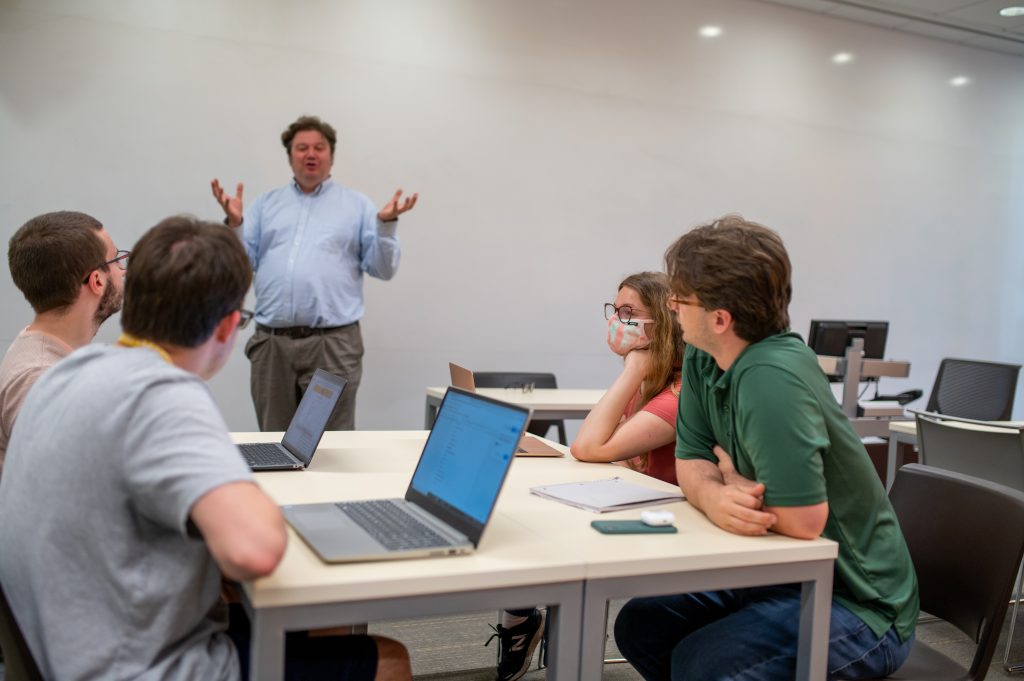 Professor Matthew Wright working with a class of Bridges to Adelphi students.