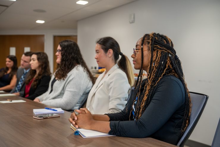 Students speaking directly with Robert B. Willumstad at a conference table