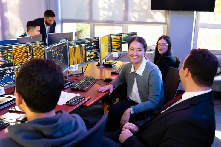 A group of students collaborating in the Trading Room at Adelphi