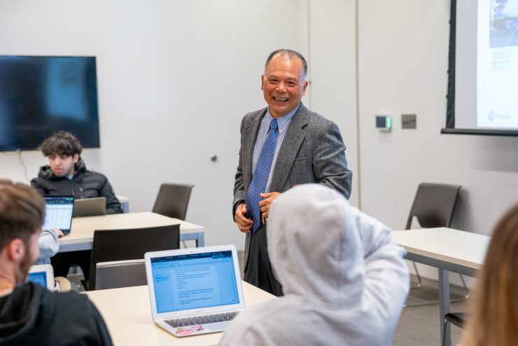 Professor Zhimin Huang teaches a business class at Adelphi University.