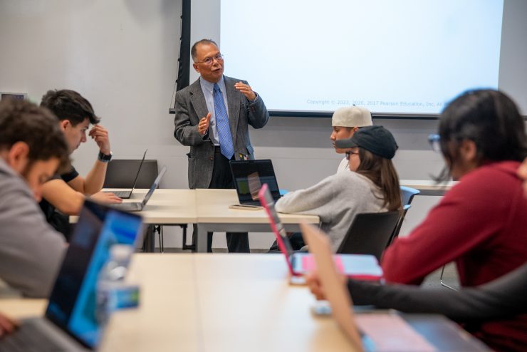 Professor Zhimin Huang  teaches a business class at Adelphi University.
