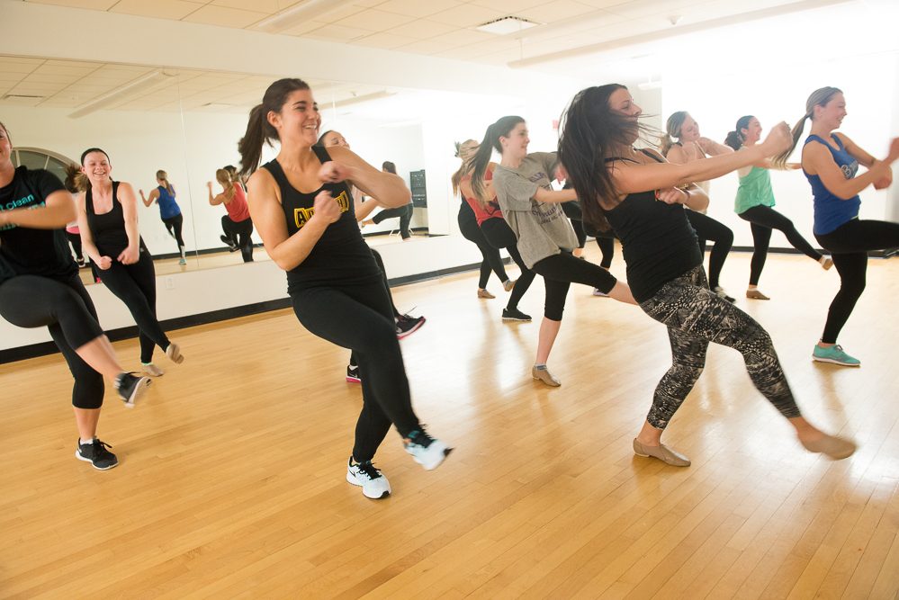 Adelphi students doing a group workout together and having fun.