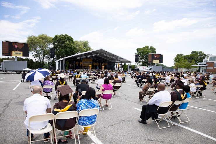 Graduating student and guests stand for pledge.