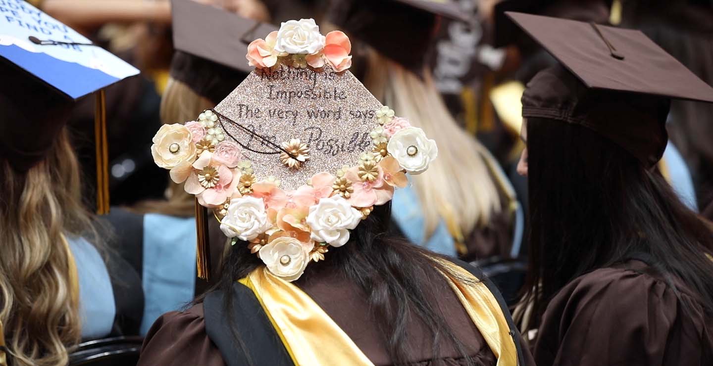 Decorated graduation cap that says: Nothing is impossible. The very word says "I'm Possible"