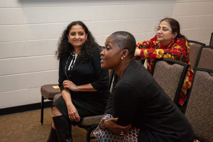 Three Adelphi faculty members in a discussion