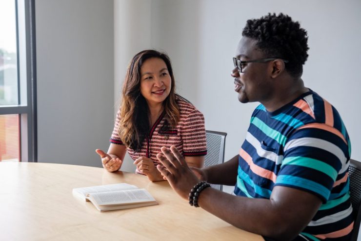 Professor Sokthan Yeng working one on one with an Adelphi Student