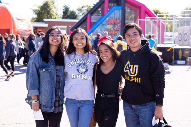 Diverse group of Adelphi students hanging out at a student event