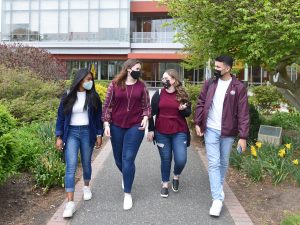Adelphi students wearing masks on campus.