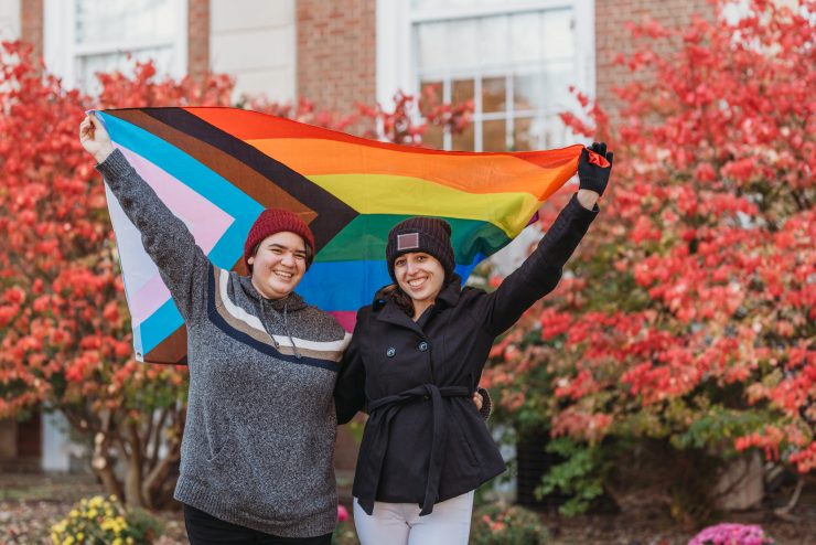 Students holding flags for transgender and pride.