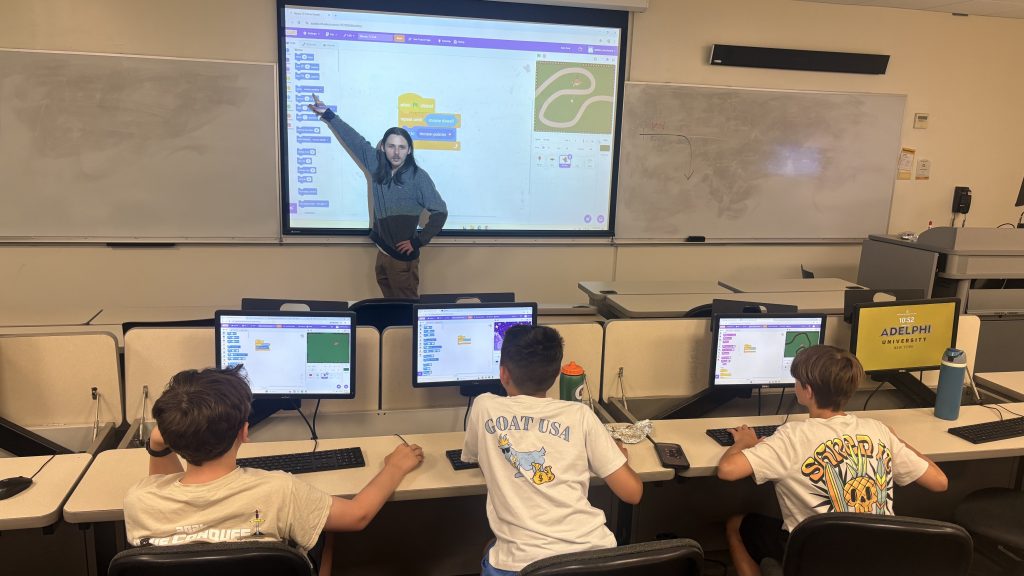 An instructor leads kids at our video game design summer camp through the basics.