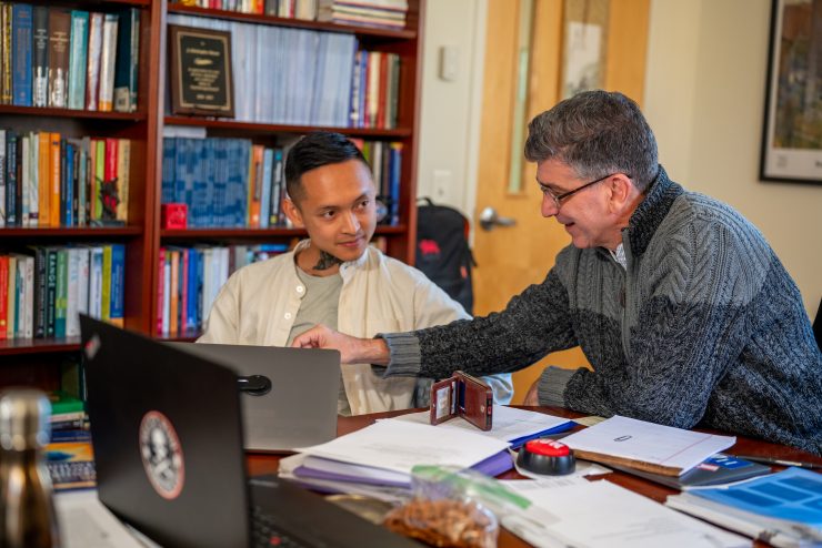 Dean Muran working hands-on with psychology student at the Derner School of Psychology
