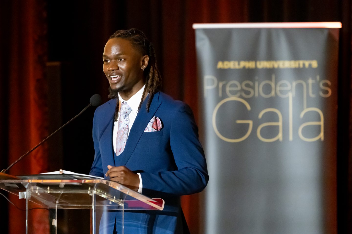 Senior Bryce Ridley, captain of Adelphi’s track and field team and a health sciences major speaks at the 2024 President's Gala