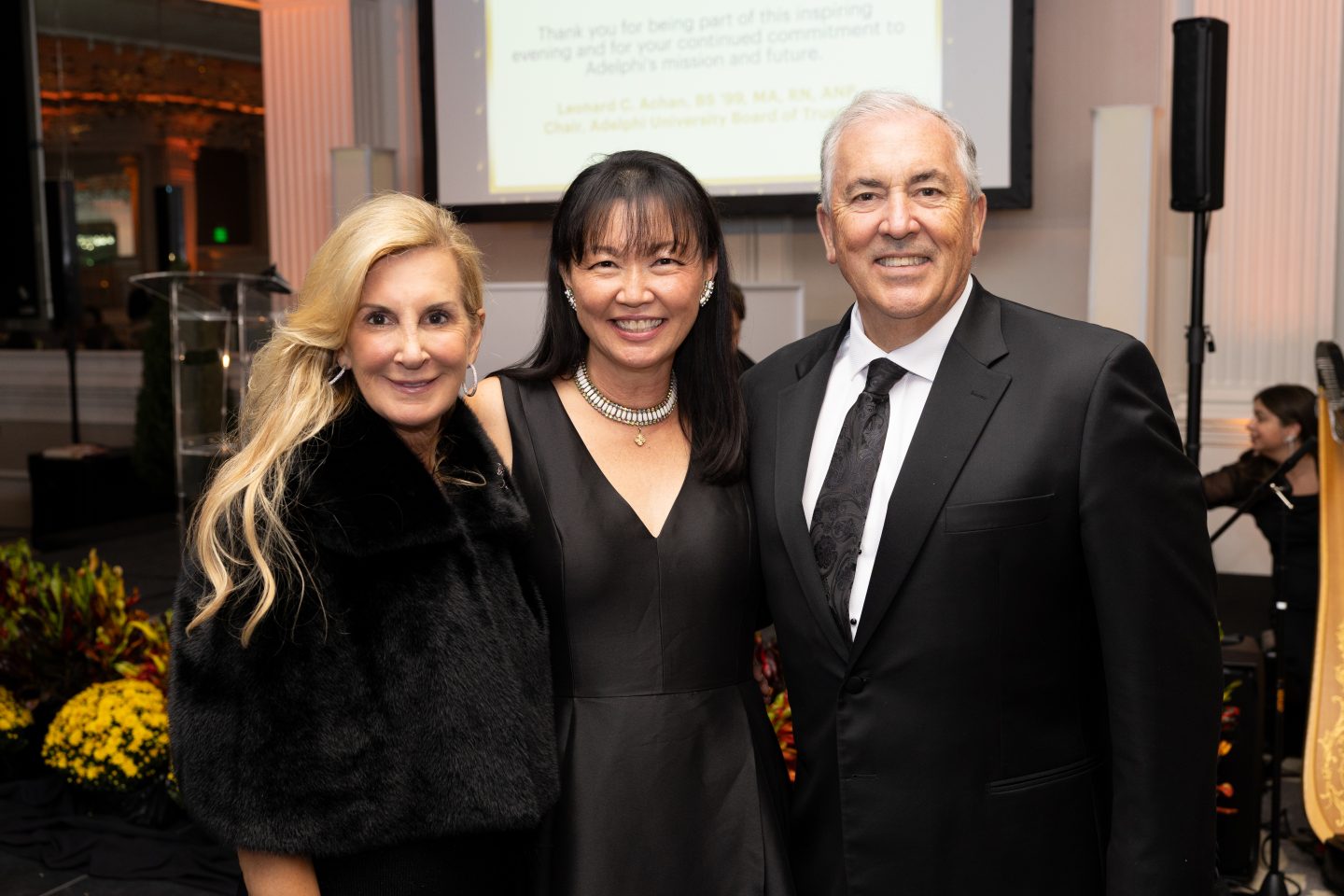 President Michael Balboni ’81, JD, with his wife, Stephanie Balboni, and Chief of Staff Maggie Yoon Grafer ’98, MA ’08.