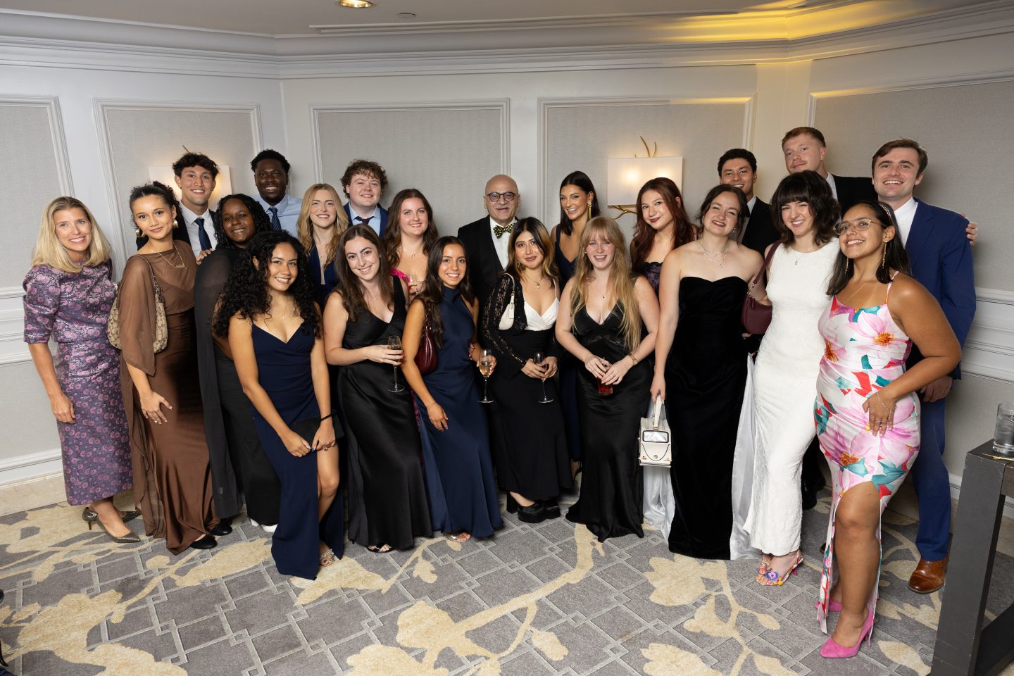 Students and alumni who participated in the Bhisé Global Learning Experience to India gather at the 2026 Adelphi University Gala with Shannon Harrison, director of the Center for International Education (far left), and Bharat Bhisé, MBA ’78 (center back, wearing a bow tie). Now in its fifth year, the program is funded by Bhisé and his firm, Bravia Capital. They also made it possible for more than 30 students to attend the gala.